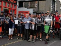 Bude Mountain Bike Riders hand over bike ride proceeds following cycle from Minehead to Plymouth
