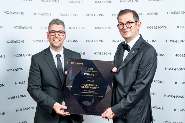 Scott Hibbard, General Manager at Sandymouth Holiday Resort receives the award from Paul Evans, Vice President - Portfolio, at Awaze â the parent company of Hoseasons (right)