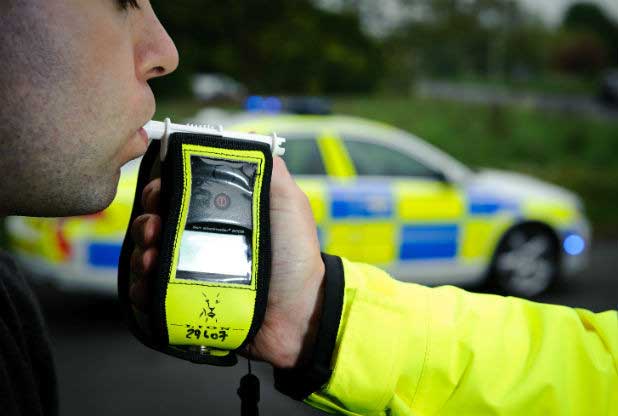 Man blowing into a breath test machine