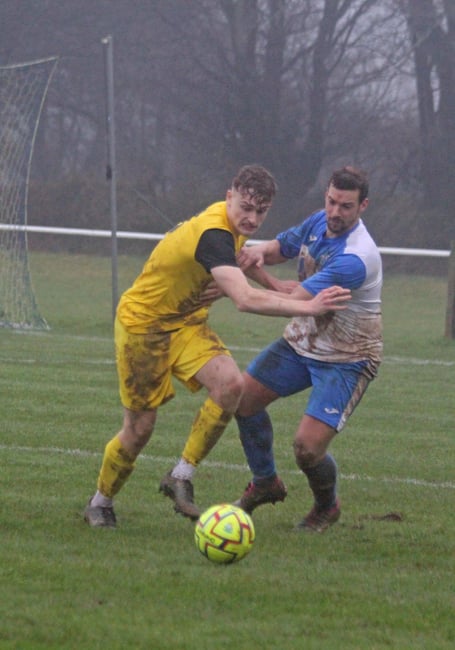 Callington's Noah Maund and Camelford's Andy Boxall battle it out in SWPL Premier West .