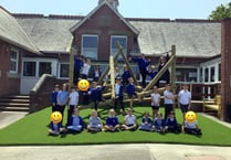 Students show off their climbing skills on new play equipment