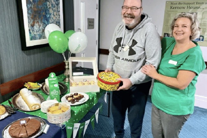Richard and Jackie choosing which cakes to have at Kernow House Care Home’s coffee morning for Macmillan Cancer Research