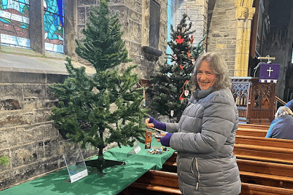Mrs Elizabeth Brown, one of the organisers of the event, putting together the WI tree
