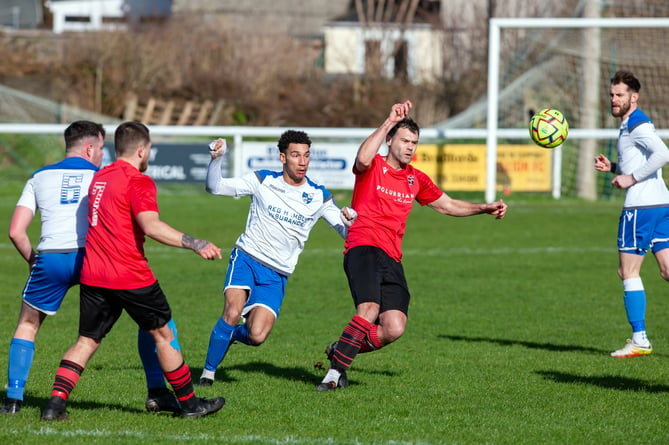 Camelford man of the match Shae Cardiff (centre in white) looks to win the ball back at Mullion on Saturday. Picture: Robin Hobson.