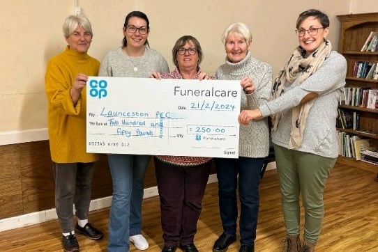 Katie Willing stood alongside others with the cheque