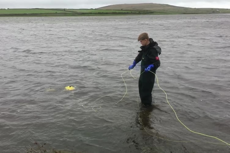 The Northants Magnet Fishing at work. Photo released April 3 2024. A team of filmmakers, magnet fishers, tech experts and divers have embarked on an outrageous quest to find - the magical sword called Excalibur.The group are searching British lakes to locate the blade said to have been thrown into the water by King Arthur.They say they have identified several possible locations of Excalibur in Britain and trying to find it for part of a new TV series called Weird Britain.Underwater camera operators, drone experts and amphibious archaeologists have joined the hunt for the mythical sword.