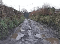 Community fight for repairs to 'dire' road littered with potholes