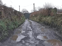 Community fight for repairs to 'dire' road littered with potholes