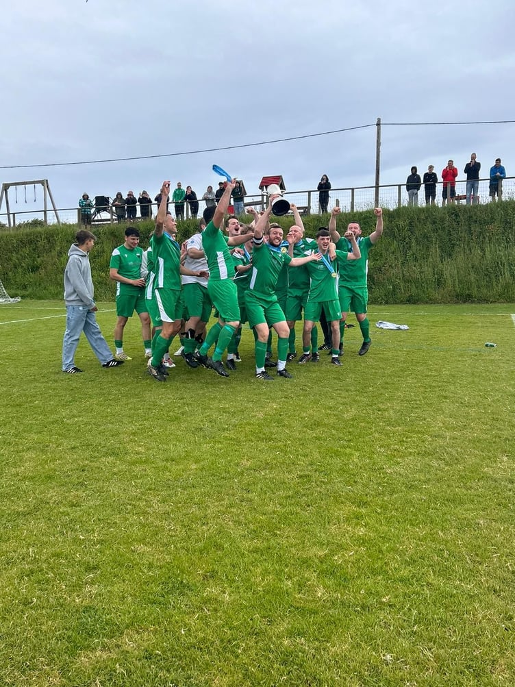 Morwenstow skipper Will Bryant and the rest of the players celebrate with the title. Picture: Morwenstow AFC
