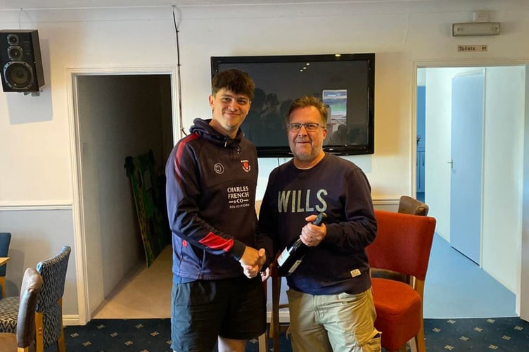 St Austell's county seamer Adam Snowdon receives his man of the match award.