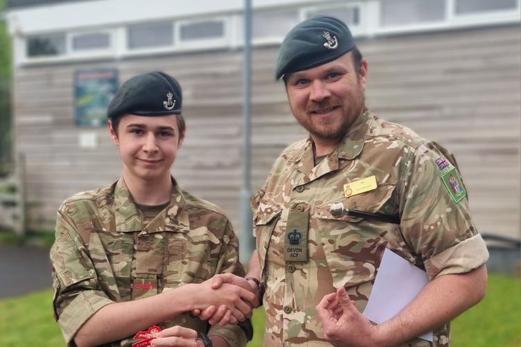 Company Serjeant Major Dave Macbeth awarded a marksman badge to LCpl Tremaine Boorman
