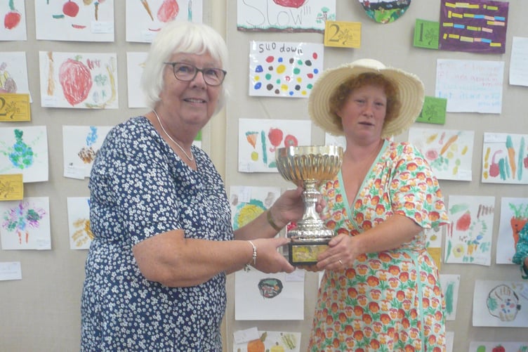 Rebecca Payne receiving the trophy for 'Most Points in the Show' and 'Best Collection of Vegetables'