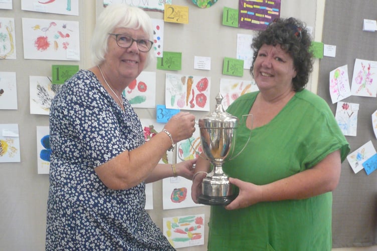 Sally Elliott receiving the trophy for 'Best Exhibit in Flower Arranging' and 'Best Exhibit in Flower Section'
