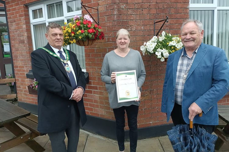 Pauline Masters, president of the Holsworthy Social Club (centre) collecting the prize on behalf of their gardener, Carol Palmer. Picture: Pauline Masters