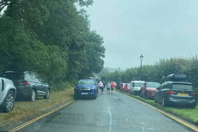 Cars parked on the grass verges and on double yellow lines outside of Bodmin Jail