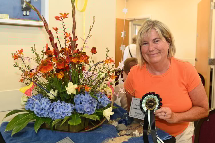 Roz Ross with first prize and special award in the Floral Art Class celebrating 200 years RNLI themed display (Picture: Adrian Jasper)