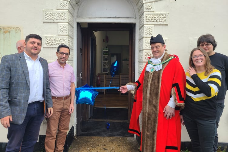 Mayor of Holsworthy, Nigel Kenneally is joined by representatives of Jhoots Pharmacy at their opening ceremony