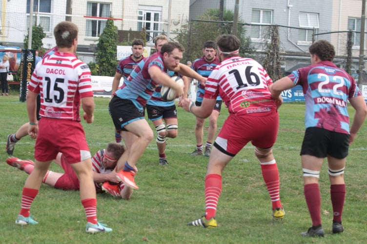 Bude winger Ed Hilliam-Cooke tries to shake off a Paignton tackle at Queens Park. Picture: Tony Berry