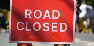 A38 closed after car overturns