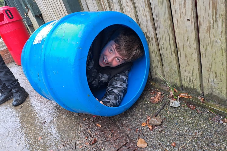 A student at Holsworthy Primary School hides in a cylindrical play device (Picture: Holsworthy Primary School)