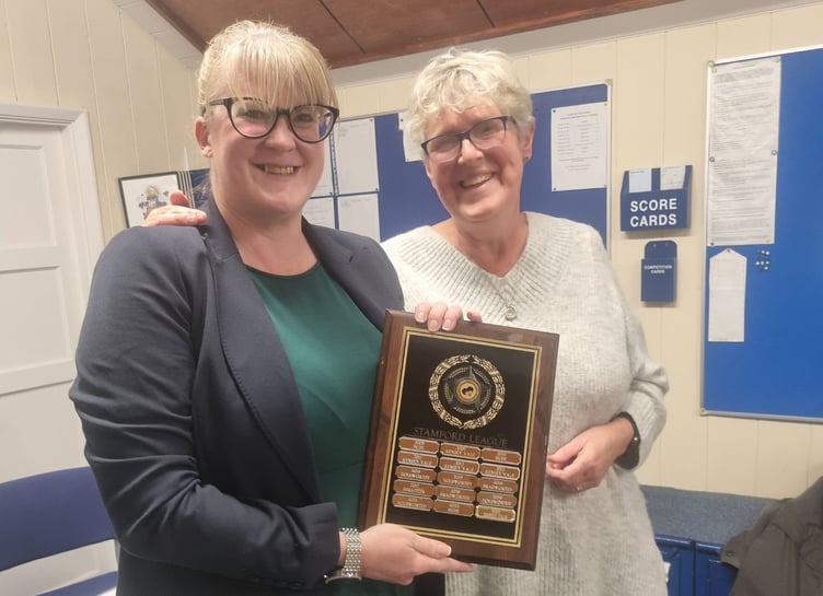 Dunheved lady captain Claire Fishleigh receives the Stamford League trophy from Bude's Jenny Horncastle. Picture: Dunheved Bowling Club