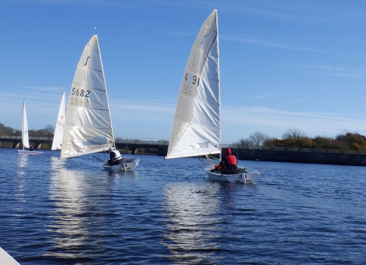 A view from on the water as Natasha Routley, crewing in Brian Pollard's Tasar, snaps the Solo battle ahead; Dave Perrett chasing Adam Hilton.
