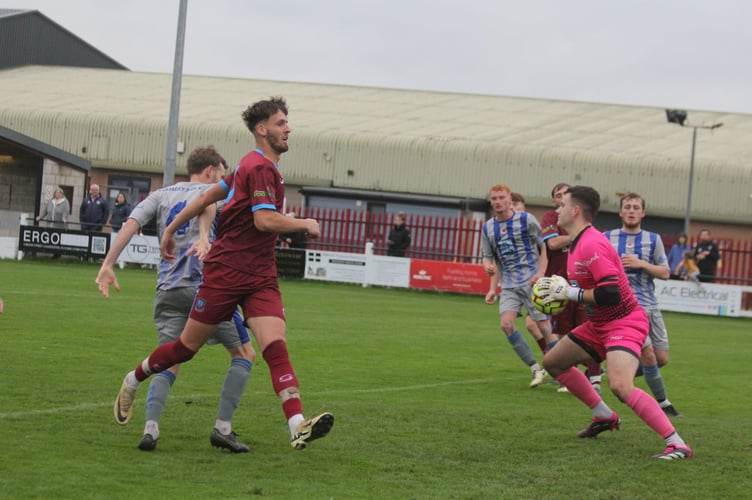 Holsworthy goalkeeper Ryan Chadwick, pictured with the ball at Launceston back in November, made two crucial stops at Burngullow Park. Picture: Paul Hamlyn