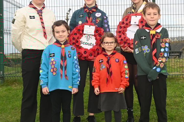 Members of the First Bude Scouts and Bude Explorer's ready to lay their wreath at the memorial 