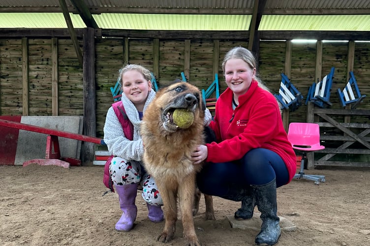 TIA and India Wardell with one of the rescue dogs that the charity has helped in the past