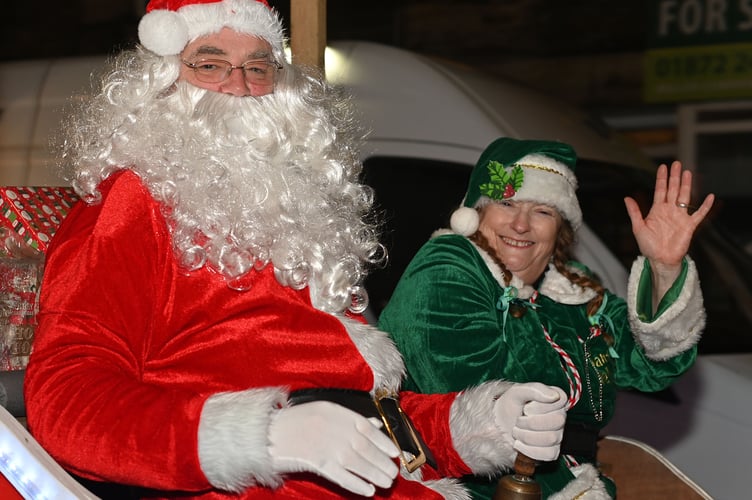 Father Christmas and Elf arrive in style for the Camelford Christmas switch-on (Picture: Adrian Jasper)