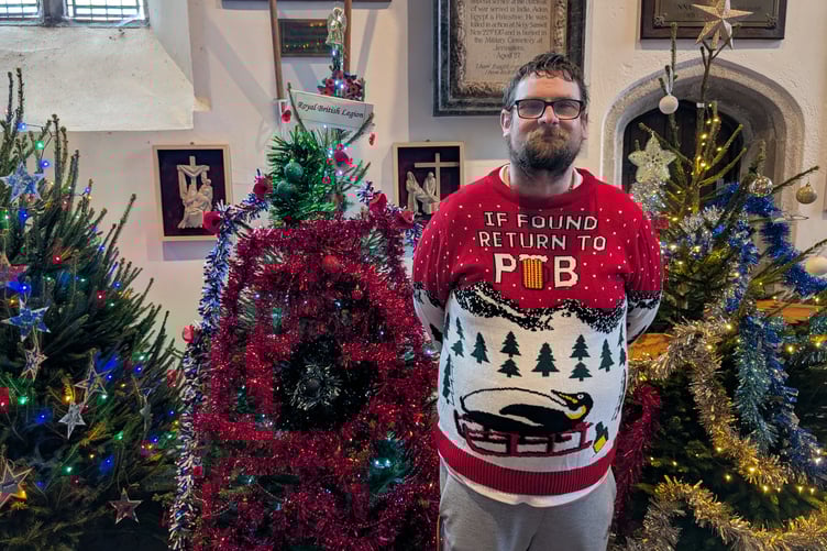 Rob Pheasant, a volunteer with the church in front of his 'favourite tree' - decorated by the town's Royal British Legion (Picture: Aaron Greenaway)