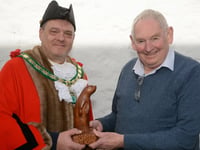 Local wood artist presents hand carved otter to town council