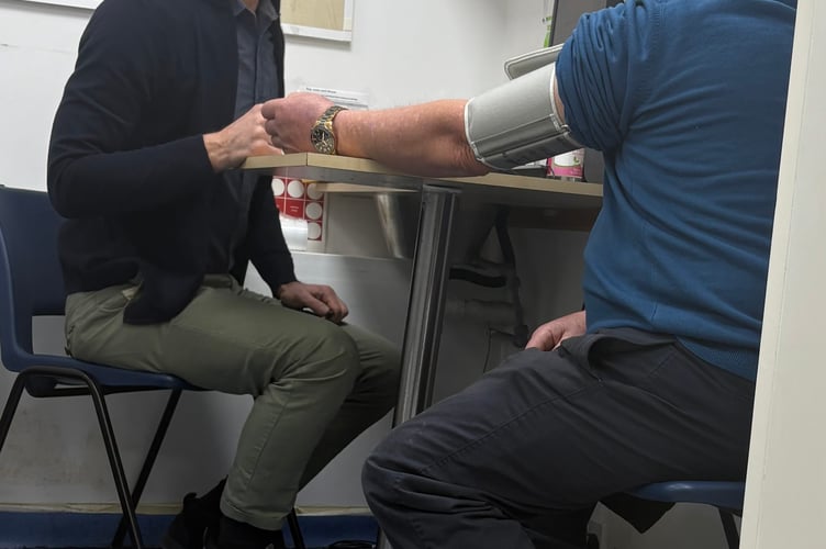Pharmacist Marco Coluccia with member of the public Trevor Jones having his blood pressure checked under the Pharmacy First scheme, piloted in Cornwall, and celebrating its first anniversary. (Picture: NHSCIOS)