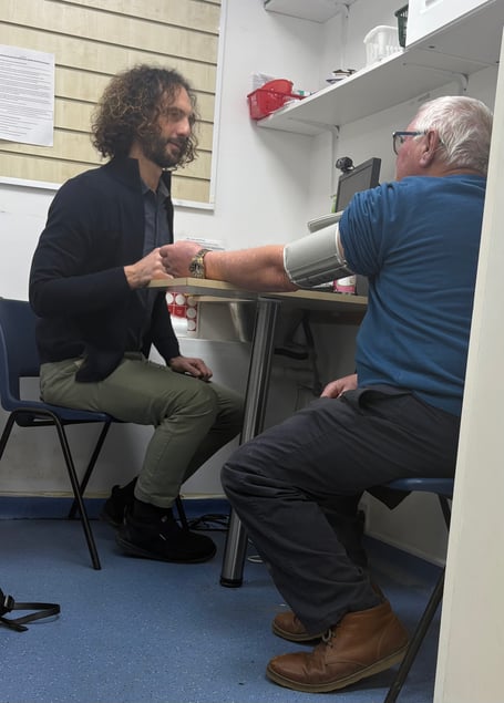 Pharmacist Marco Coluccia with member of the public Trevor Jones having his blood pressure checked under the Pharmacy First scheme, piloted in Cornwall, and celebrating its first anniversary. (Picture: NHSCIOS)
