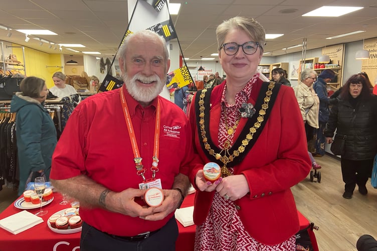 Cornwall Air Ambulance volunteer Paul Ford with the mayor of Launceston Cllr Helen Bailey enjoying a cake at the official opening of the new Cornwall Air Ambulance charity shop on High Street on Friday, March 21