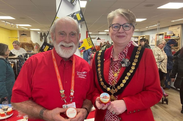 Cornwall Air Ambulance volunteer Paul Ford with the mayor of Launceston Cllr Helen Bailey enjoying a cake at the official opening of the new Cornwall Air Ambulance charity shop on High Street on Friday, March 21 (Picture: Zoë Uglow)