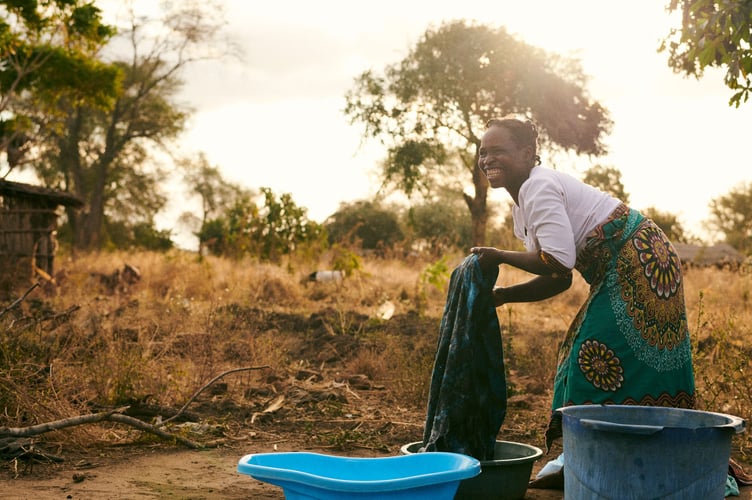 Sileni Gunizani, 33, washing clothes with clean water in M’doko, Malawi