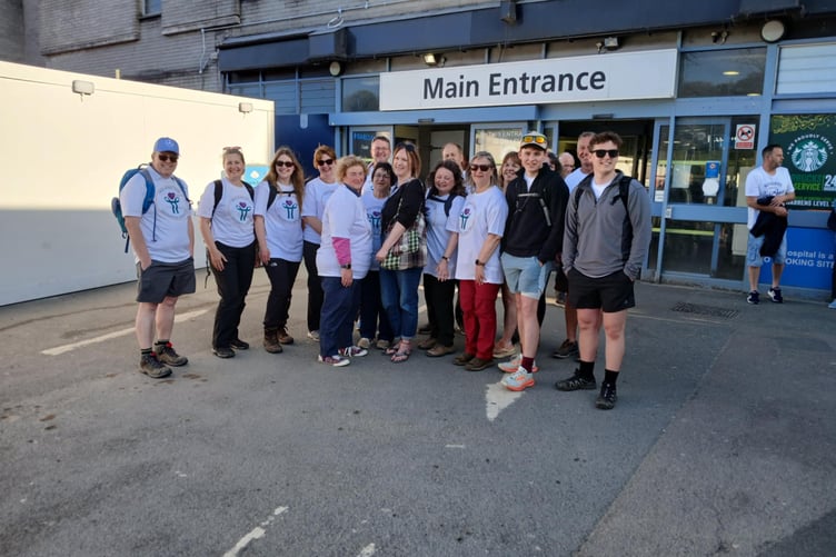 The team greeted by lead gynaecological oncology nurse Nikki Calder, at the main entrance after they finish their 12-hour walk. (Picture: Kay Barriball)