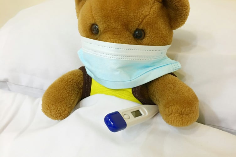 File image of a teddybear in a hospital bed with a mask and thermometer (Picture: Kristine Wook/Unsplash) 