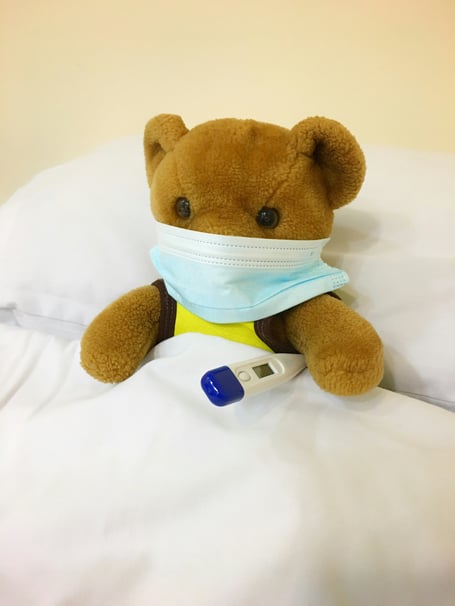 File image of a teddybear in a hospital bed with a mask and thermometer (Picture: Kristine Wook/Unsplash)