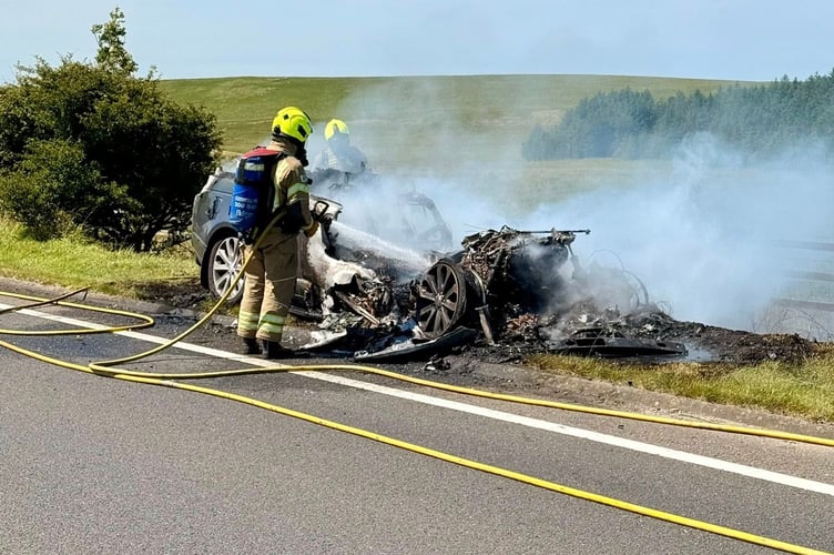 Fire crews extinguishing the car which caught on fire at Bolventor. (Picture: Launceston Community Fire Station)