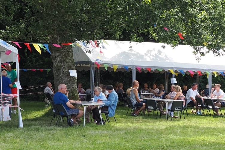 Woburn Residents’ Association enjoying a cream tea on the Woburn Green. (Picture: John Ellacott)