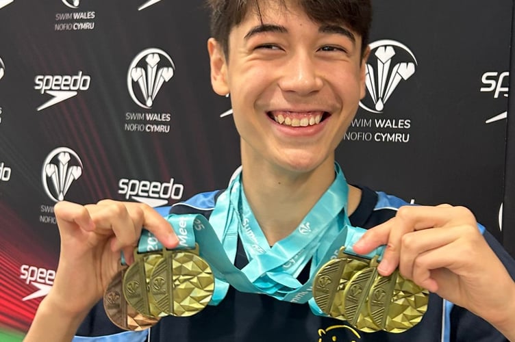 Okehampton Otters swimmer Callum Davies proudly showing off his four Welsh National Champs winner's medals.