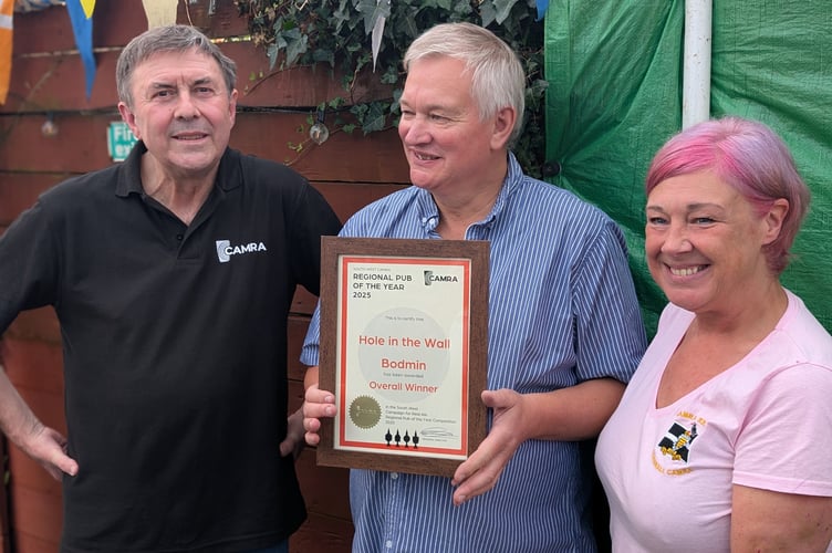 Pete Bridle (left), the regional director of CAMRA South West is pictured with the Hole in the Wall landlord Steve Hall and bar manager Ruth Howiantz (Picture: Aaron Greenaway)