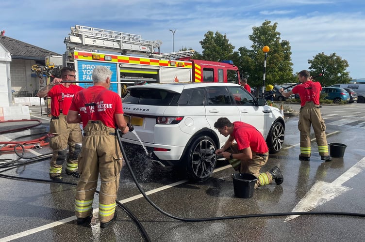 Fire crews from Wadebridge Fire Station washing a car (Picture: Cornwall Fire and Rescue Service)