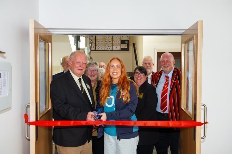 Kevin Hicks and Rachel Miller cutting the ribbon at the new clubhouse entrance.