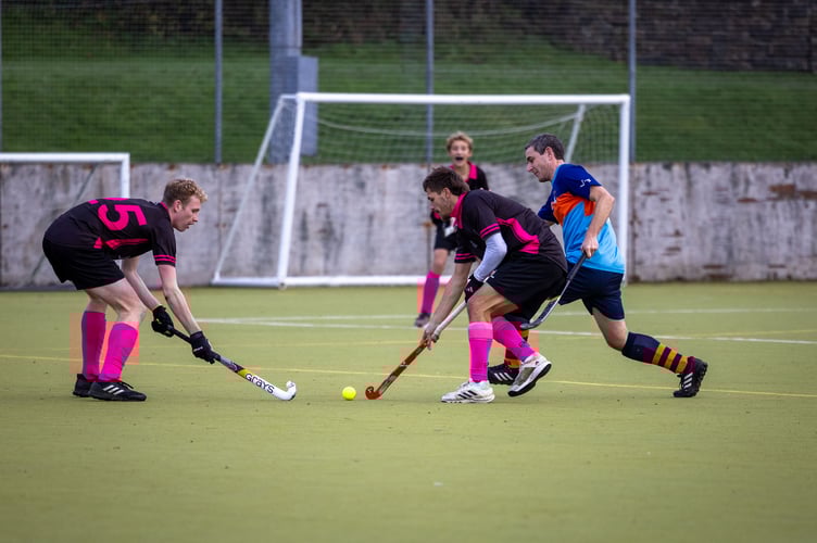 man of the match Charlie Falla protecting the ball from the North Devon player and working closely with fellow goal scorer Zack Davis.