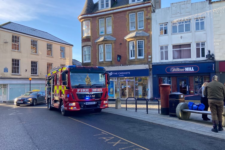 A cordon is being put in place whilst fire crews investigate at the Launceston Boots store
