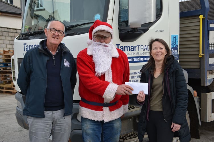 John Addicott and Andrew Braunton handing the money raised to Julia Foster.  (Picture: Rodney Parrish)