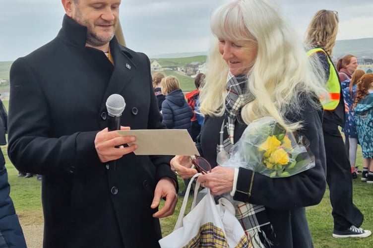 Ian Saltern presenting Jaqi Heard with flowers